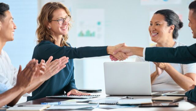 Deal handshake of business people in business meeting for trust, cooperation and collaboration. Wel