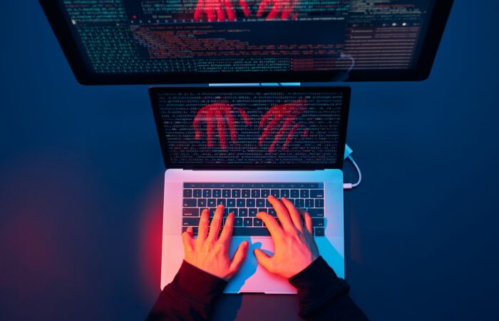 Man using computer and programming to break protection. Cyber security threat. Cyber attack
