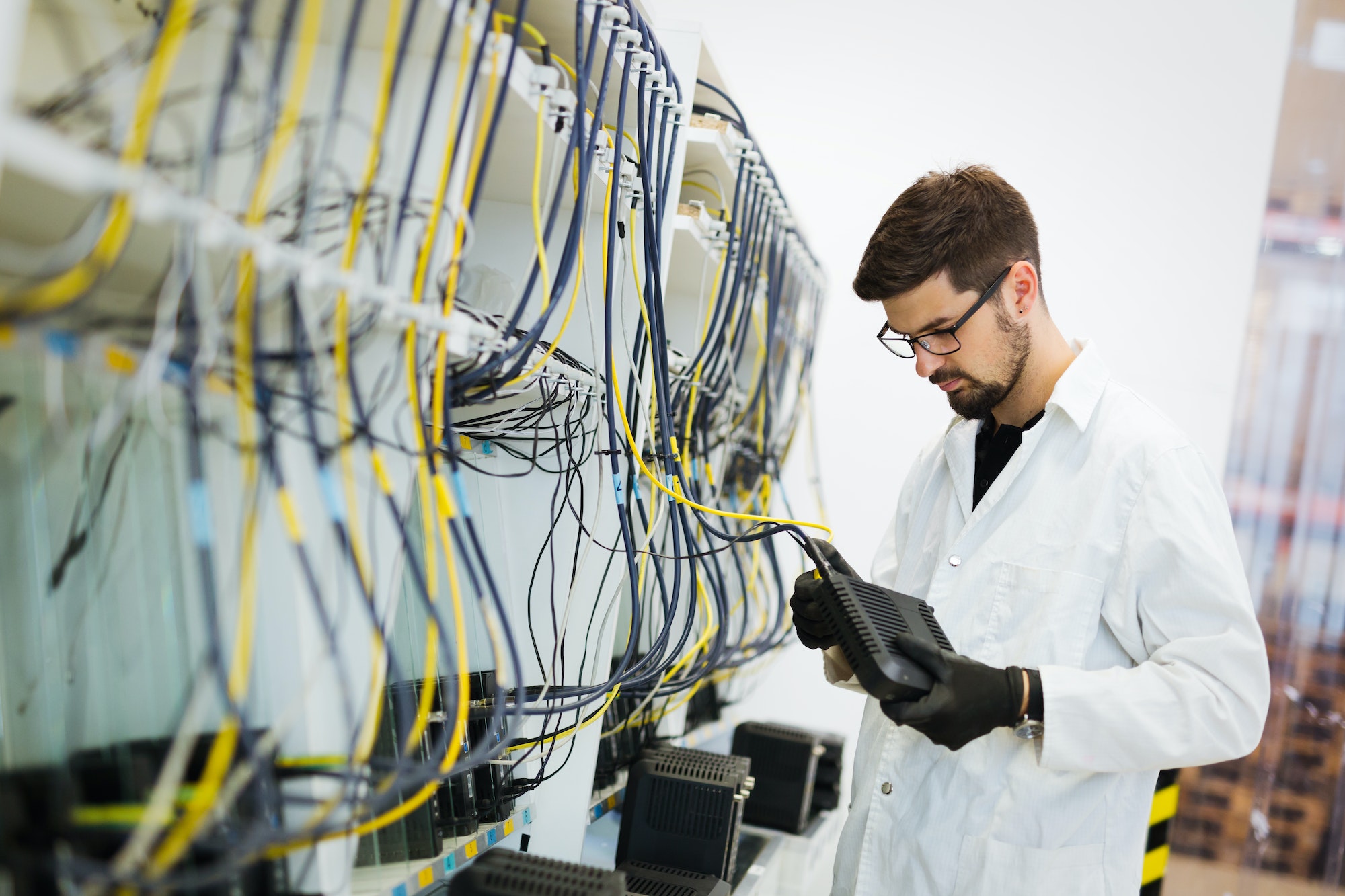 Picture of network technician testing modems in factory